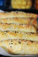 Turkish baked cakes with white sesame and black cumin on baking paper
