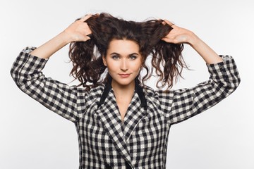 Portrait of a beautiful young woman in a black-and-white checked jacket