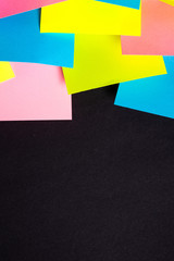Many colorful sticky notes on black background