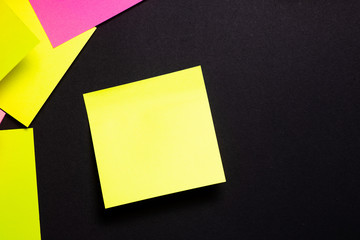 Many colorful sticky notes on black background