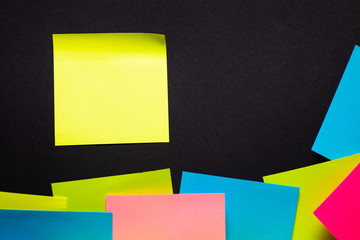 Many colorful sticky notes on black background