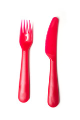 set of red baby plastic fork and knife on white background
