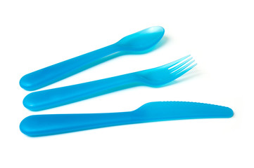 set of blue baby plastic spoon, fork and knife on white background