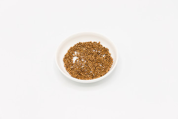 mustard seeds in white bowl
