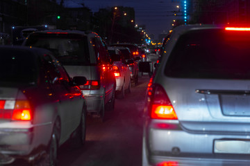 evening dense traffic of cars in the city in the winter in a small blur