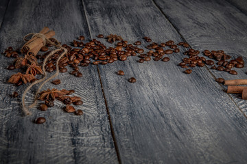 Coffee beans on wood background. Dark still life, top view