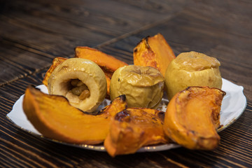 Baked pumpkin and apples on plate