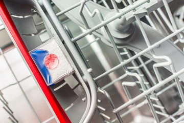 Powder tablet lies in the shelf compartment in the dishwasher