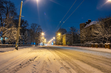 Snowbound city street at night