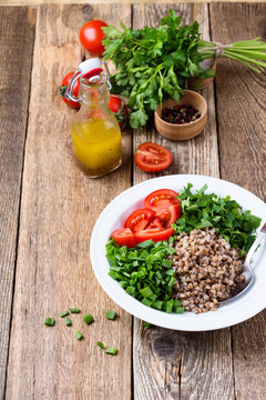 Healthy cooked buckwheat grain salad with fresh vegetables