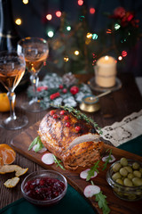 Grilled pork loin on the Christmas table with Christmas lights in the background