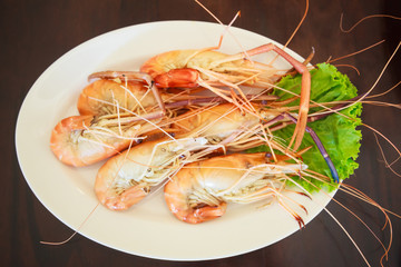 Steamed Seafood from sea market, Fresh Tasty Appetizing Cooked Tiger Prawns on Wooden Table Background. Food, Nutrition, Allergy, Aquatic food supply, Healthy Meal, Sea Beach and River Cuisine concept