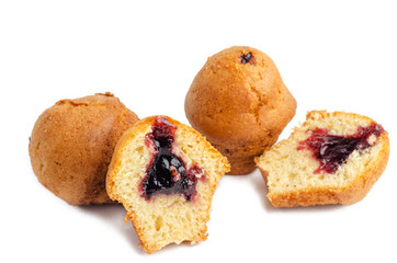 Tasty muffins stuffed with berry jam on white background