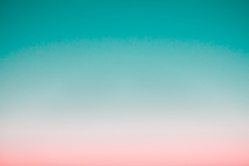 Surreal predawn clear sky with pink horizon and green atmosphere. Smooth pink green gradient of...