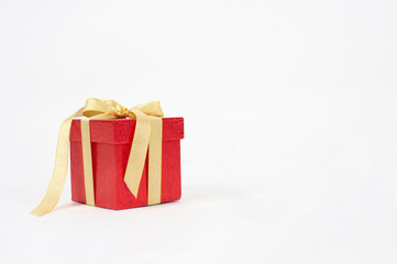 Red gift box with golden ribbon bow isolated on white background - Image