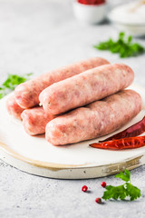 Raw sausages with spices, herbs. Selective focus, space for text.