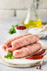 Raw sausages with spices, herbs. Selective focus, space for text.