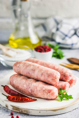 Raw sausages with spices, herbs. Selective focus, space for text.