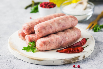 Raw sausages with spices, herbs. Selective focus, space for text.