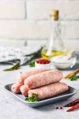 Raw sausages with spices, herbs. Selective focus, space for text.