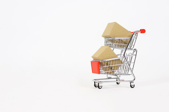 Paper boxes in a small shopping. Concepts about online shopping that consumers can buy things directly from their home or office just using a few clicks via web browser. - Image