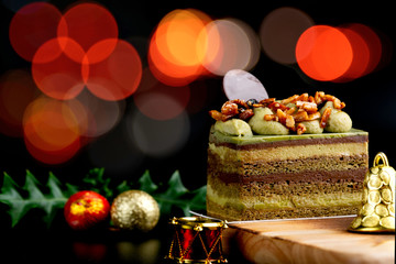 Chocolate and green tea cake on wooden table for celebrate in christmas and new year festival.