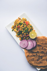 Paneer Bhurji, mildly spiced cottage cheese scramble and served with roti or laccha paratha, selective focus