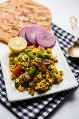 Paneer Bhurji, mildly spiced cottage cheese scramble and served with roti or laccha paratha, selective focus