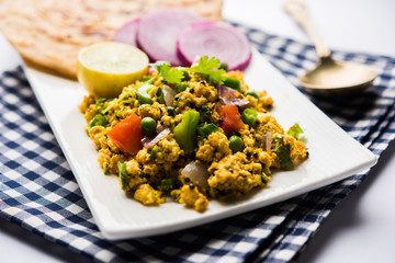 Paneer Bhurji, mildly spiced cottage cheese scramble and served with roti or laccha paratha, selective focus