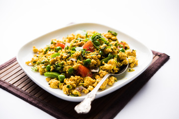 Paneer Bhurji, mildly spiced cottage cheese scramble and served with roti or laccha paratha, selective focus