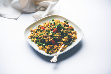 Paneer Bhurji, mildly spiced cottage cheese scramble and served with roti or laccha paratha, selective focus