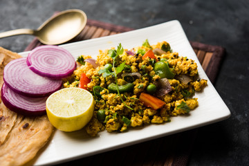 Paneer Bhurji, mildly spiced cottage cheese scramble and served with roti or laccha paratha, selective focus