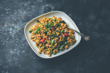 Paneer Bhurji, mildly spiced cottage cheese scramble and served with roti or laccha paratha, selective focus
