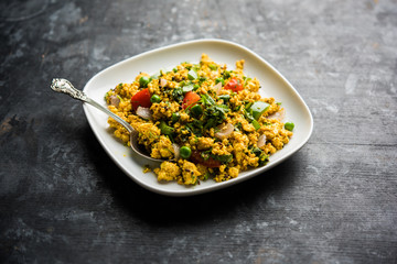 Paneer Bhurji, mildly spiced cottage cheese scramble and served with roti or laccha paratha, selective focus