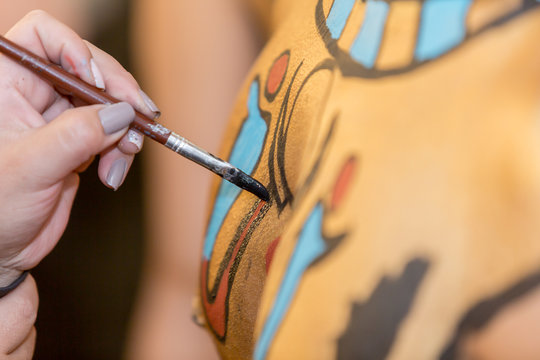 Bodyart in progress. Young male latino body art