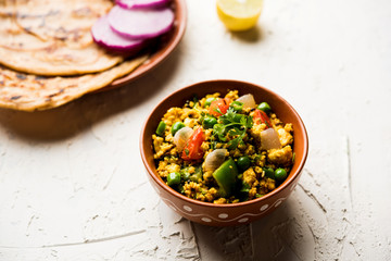 Paneer Bhurji, mildly spiced cottage cheese scramble and served with roti or laccha paratha, selective focus