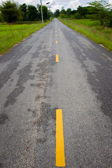 Old asphalt street and lens line close up.