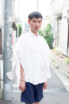 Asian male model poses for pictures on the street