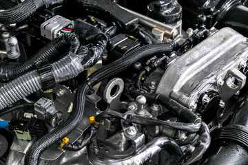 Fototapeta premium Car engine. Car engine part. Close-up image of an internal combustion engine. Engine detailing in a new car. Car detailing