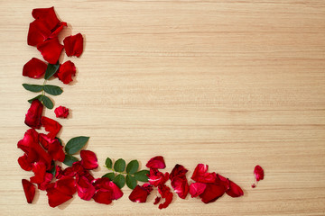 frame red roses petals on wooden