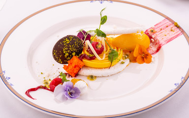 A tropical coconut meringue dessert with passion fruit and mango 