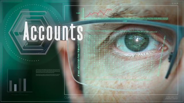 A close up of a businessman eye controlling a futuristic computer system with an Accounts concept.