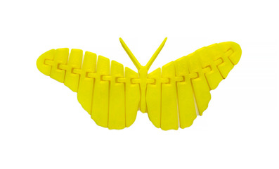 Bright light yellow object in shape of butterfly toy printed on 3d printer isolated on white background. Fused deposition modeling, FDM. Concept modern progressive additive technology for 3d printing.