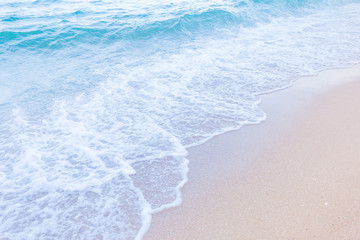 Blue sea waves splash on a beach. Summer sunny day on the beach