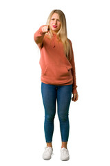 Fototapeta premium A full-length shot of a Young girl frustrated by a bad situation and pointing to the front on isolated white background