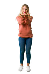 A full-length shot of a Young girl holding copyspace imaginary on the palm to insert an ad on isolated white background