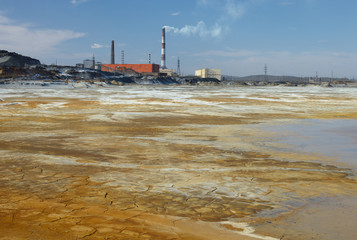 Fototapeta na wymiar The desert area is polluted with toxic waste near the territory of the copper smelting plant.