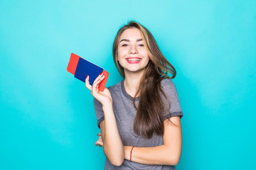 Young Woman traveler with passport and ticket on blue background