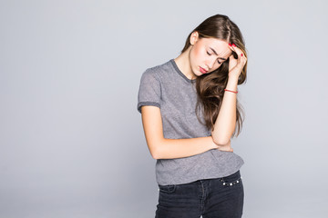 Young beautiful woman in depression isolated on gray background