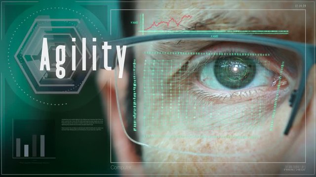 A close up of a businessman eye controlling a futuristic computer system with an Agility concept.
